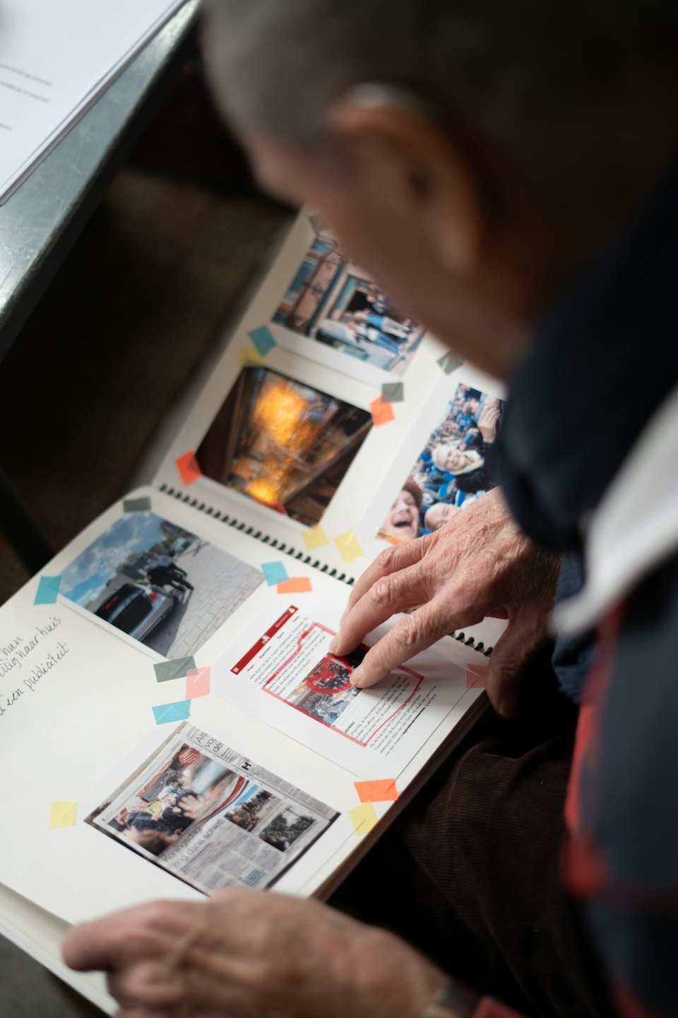 Person looking at a scrapbook of memories.